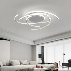 White spiral swirl flush mount LED ceiling light fixture mounted on a white ceiling in a living room.