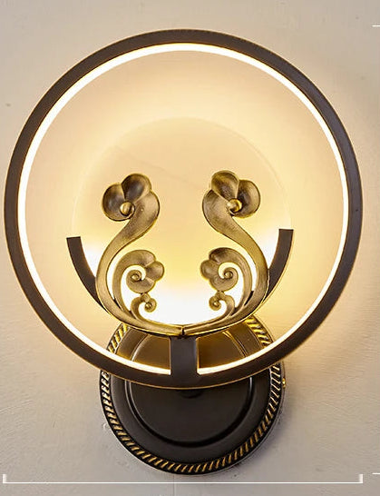 Decorative wall lamp with gold accents on a light gray background