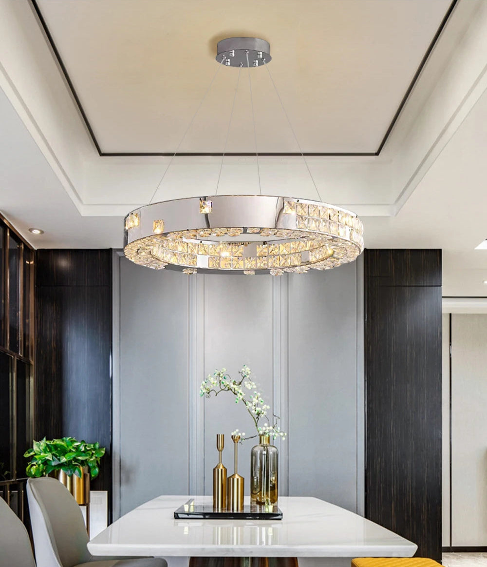 Modern chandelier hanging above a dining table in a stylish room.
