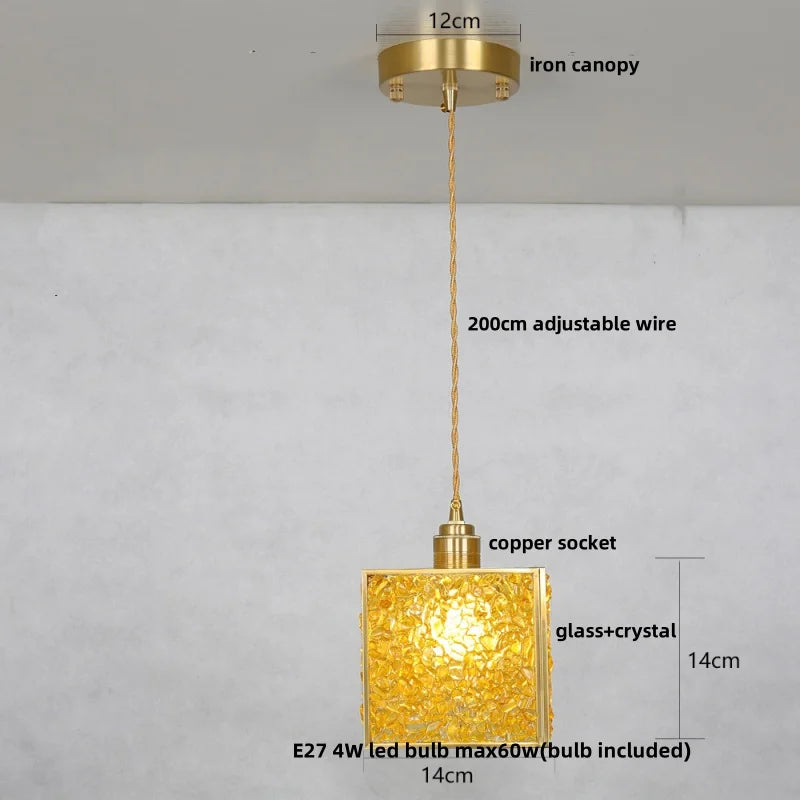 Gold pendant light with labeled parts on a gray background