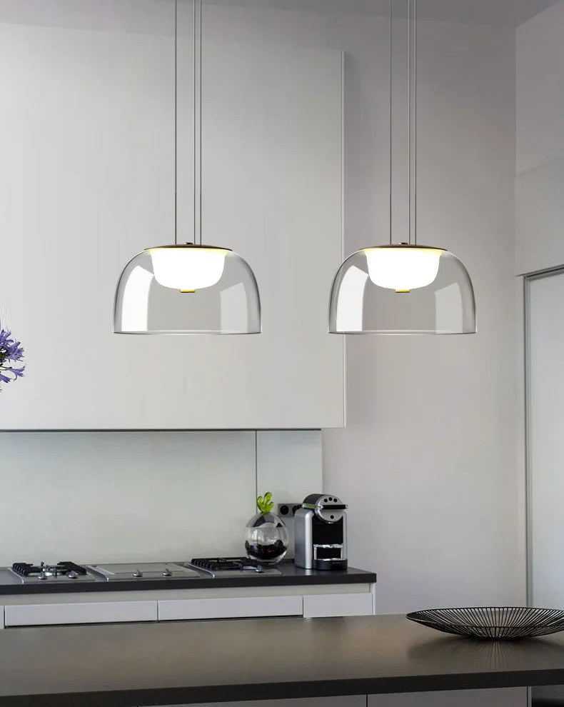 Modern kitchen with pendant lights hanging above a countertop.