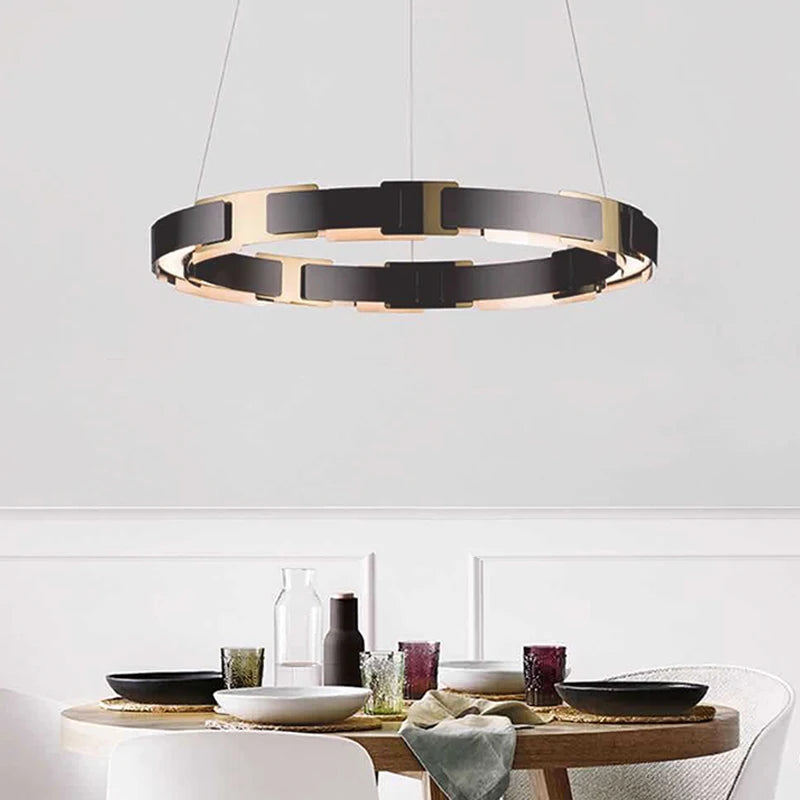 Modern pendant light hanging above a dining table with a white wall background