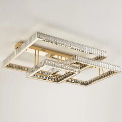 Close-up view of a gold geometric flush mount ceiling light with multiple rectangular frames adorned with clear crystals, showcasing the light reflection.