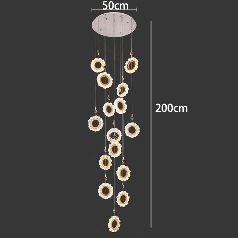 Decorative hanging mobile with floral designs and measurement labels on a black background