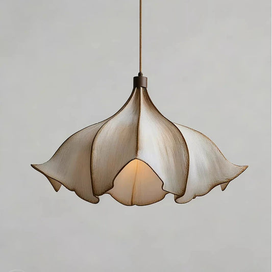 Close-up of a beige floral pendant light with petal-shaped lampshade and iron fitting, against a plain background.