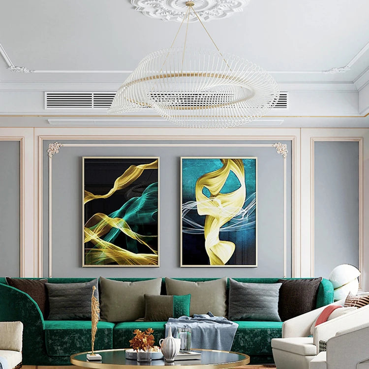 Modern living room with green sofa, abstract art on the wall, and decorative items.