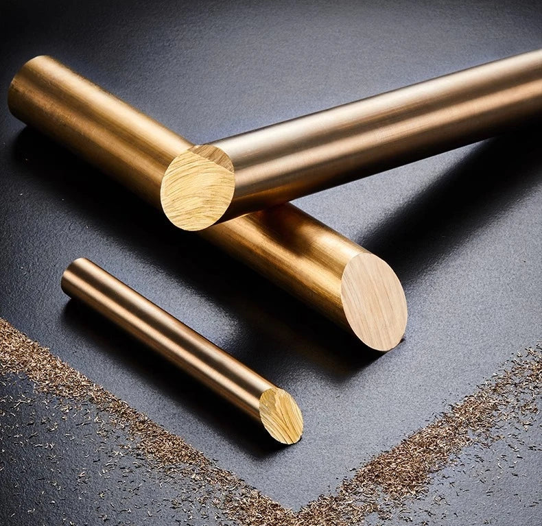 Gold metal rods on a dark surface.