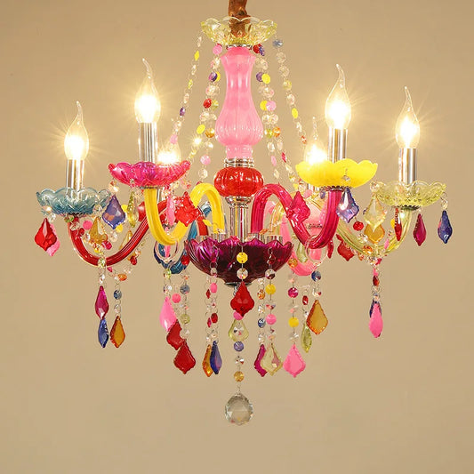 Close-up view of a colorful crystal chandelier with five lit candle-style bulbs. The chandelier features a pink central stem, multiple arms with colorful crystal accents, and assorted colored fabric shades.