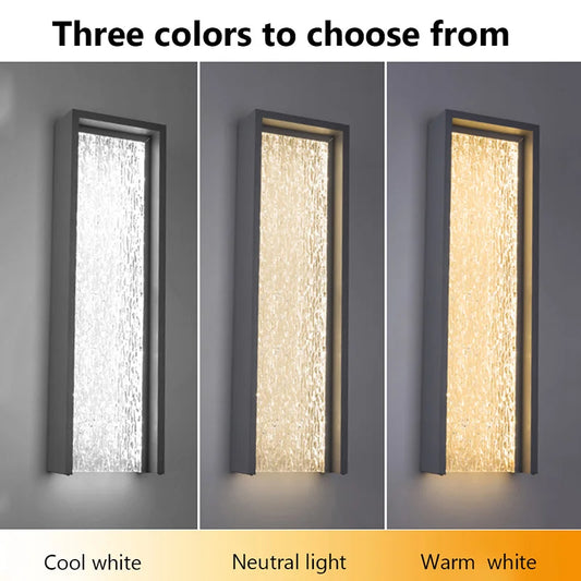 Grey rectangle wall sconce with textured glass in cool white light.