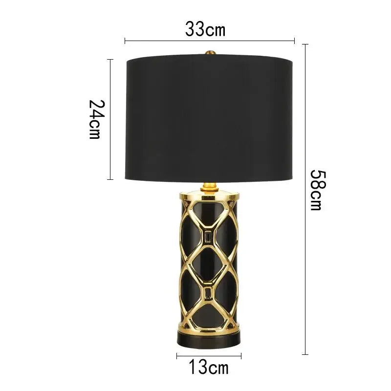Black table lamp with gold accents and measurements on a white background