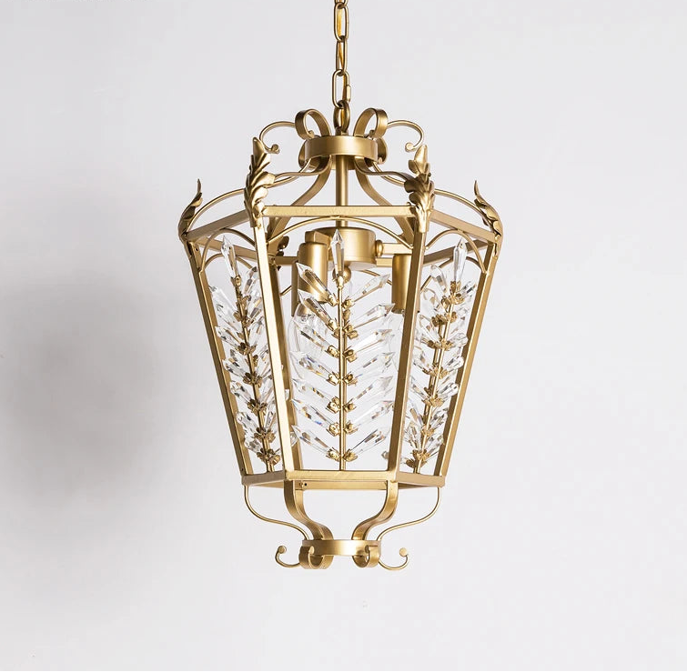 Decorative gold pendant light with intricate design on a white background
