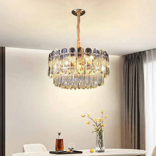 Close-up of the tiered gold crystal chandelier, showcasing the intricate crystal arrangement and polished gold frame.