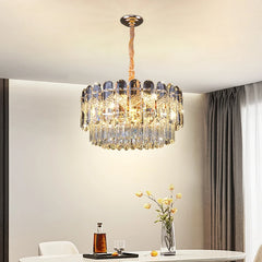 Close-up of the tiered gold crystal chandelier, showcasing the intricate crystal arrangement and polished gold frame.
