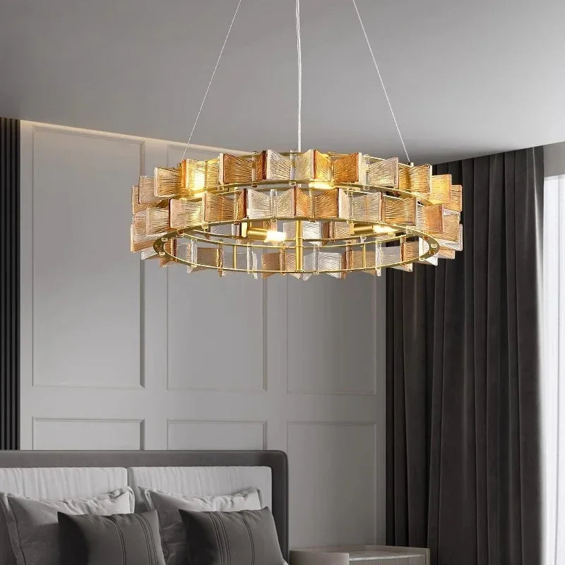 A bedroom with a gold ring chandelier adorned with amber faceted glass crystals.