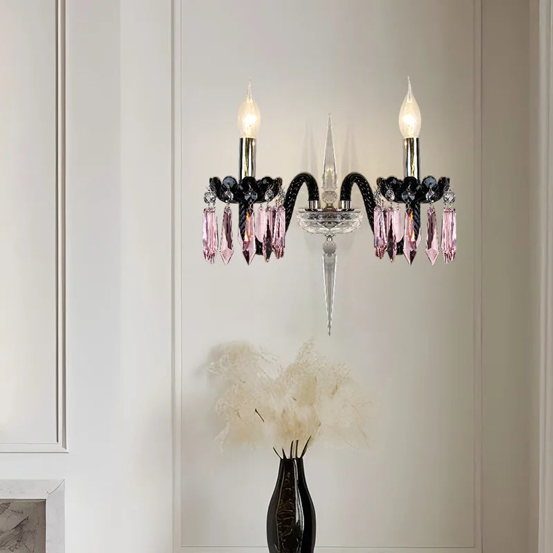 A close-up of a two-light wall sconce with multi-colored crystal accents, matching the chandelier design.