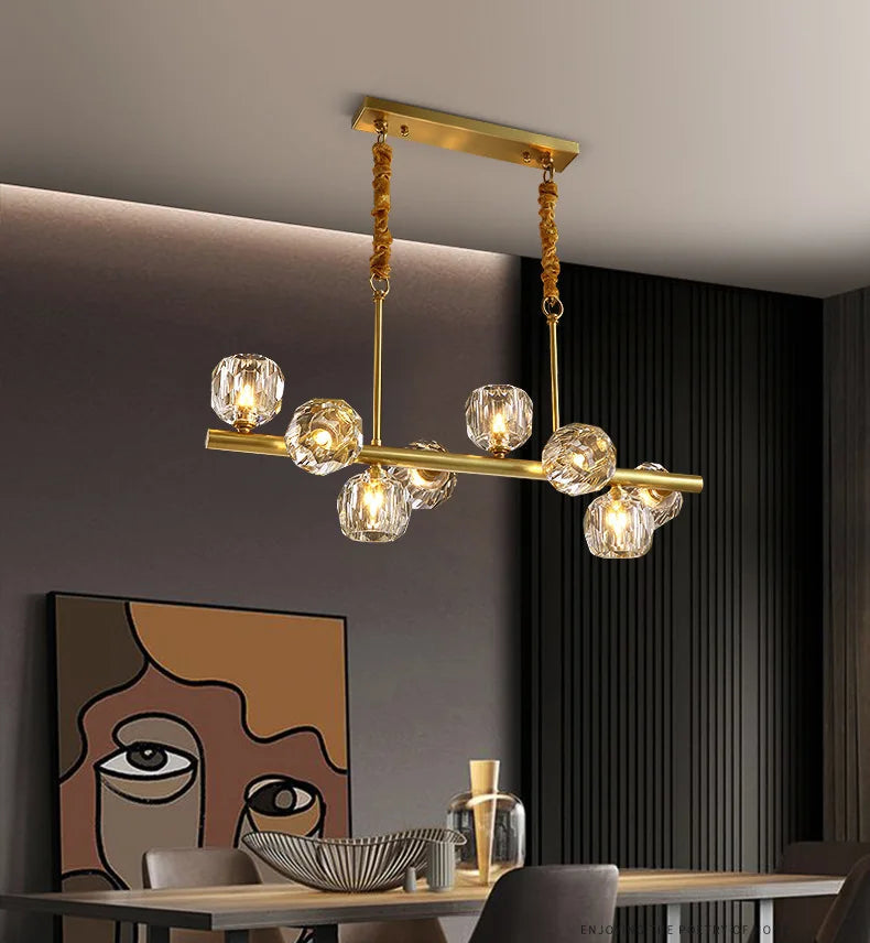 Modern chandelier with glass bulbs in a dining room setting.