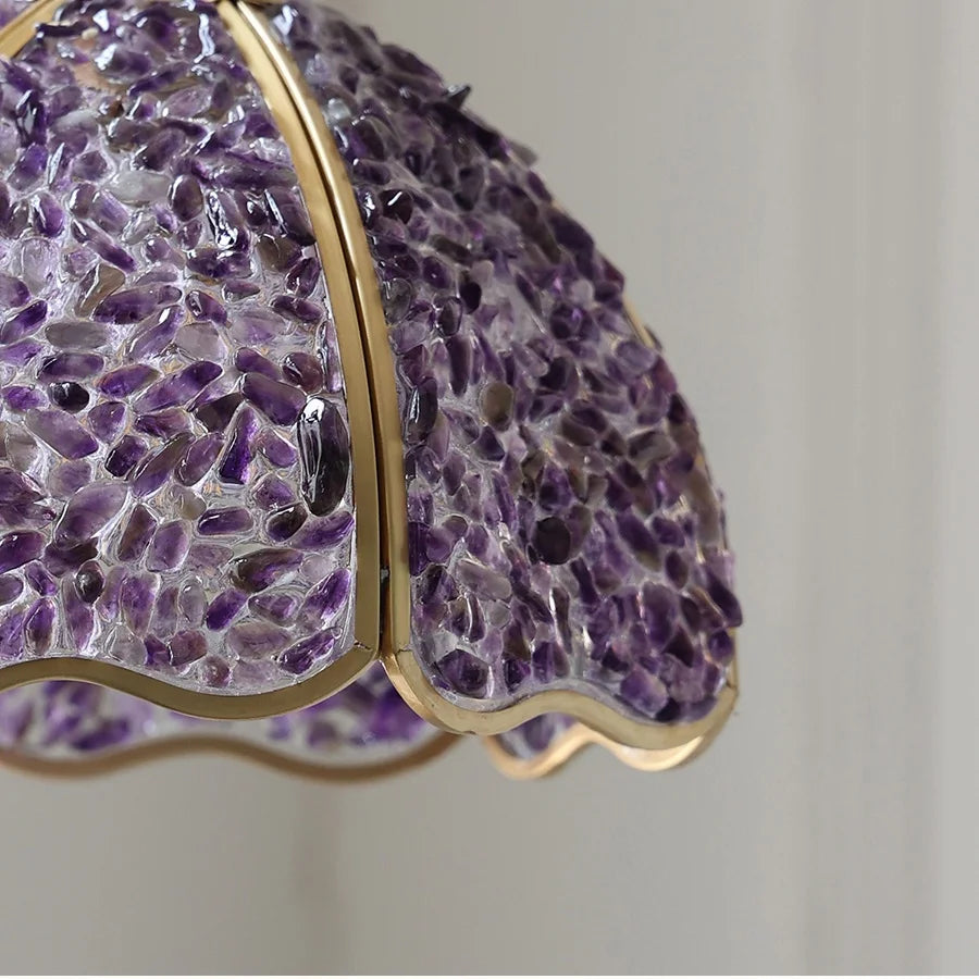 Close-up of a purple textured object with gold trim on a neutral background