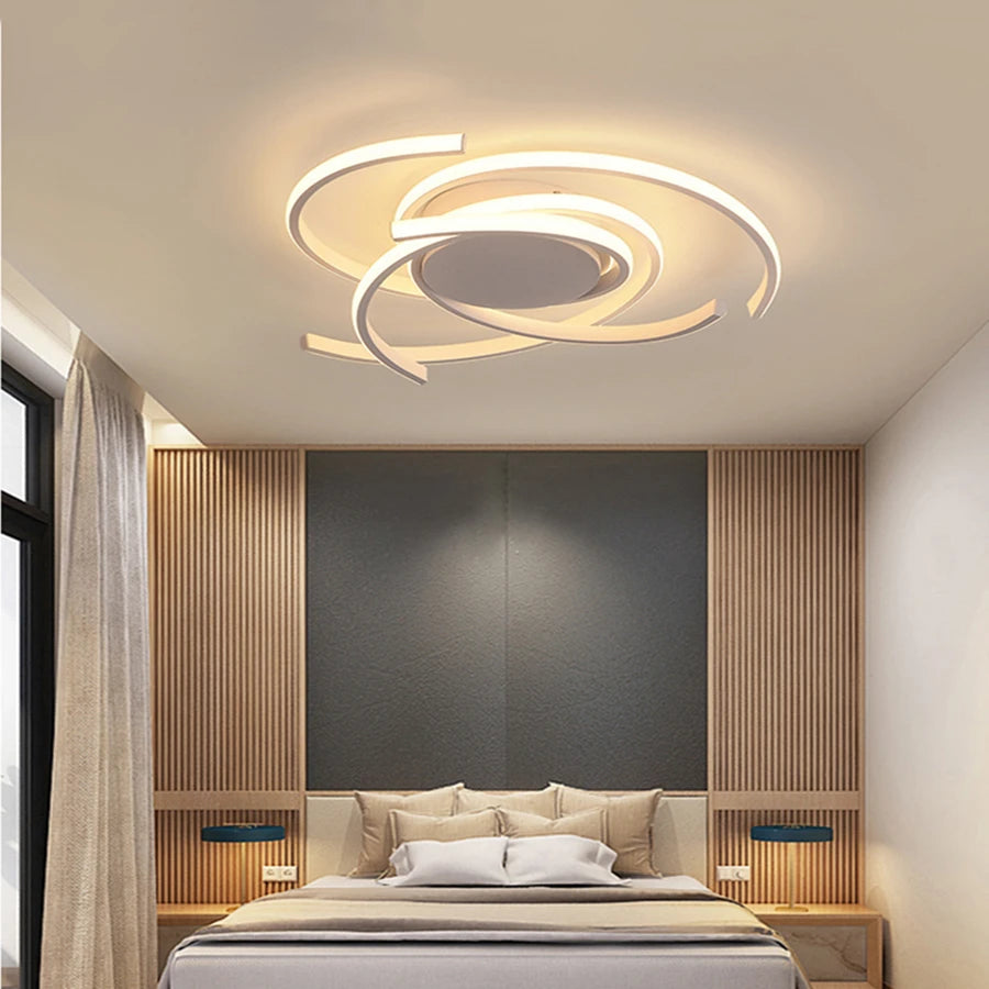 Another angle of the black spiral swirl LED flush mount ceiling light illuminating a bedroom.