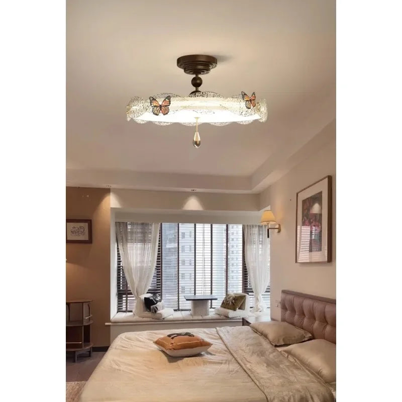View of the bronze butterfly drum semi-flush ceiling light from a different angle in a bedroom setting.