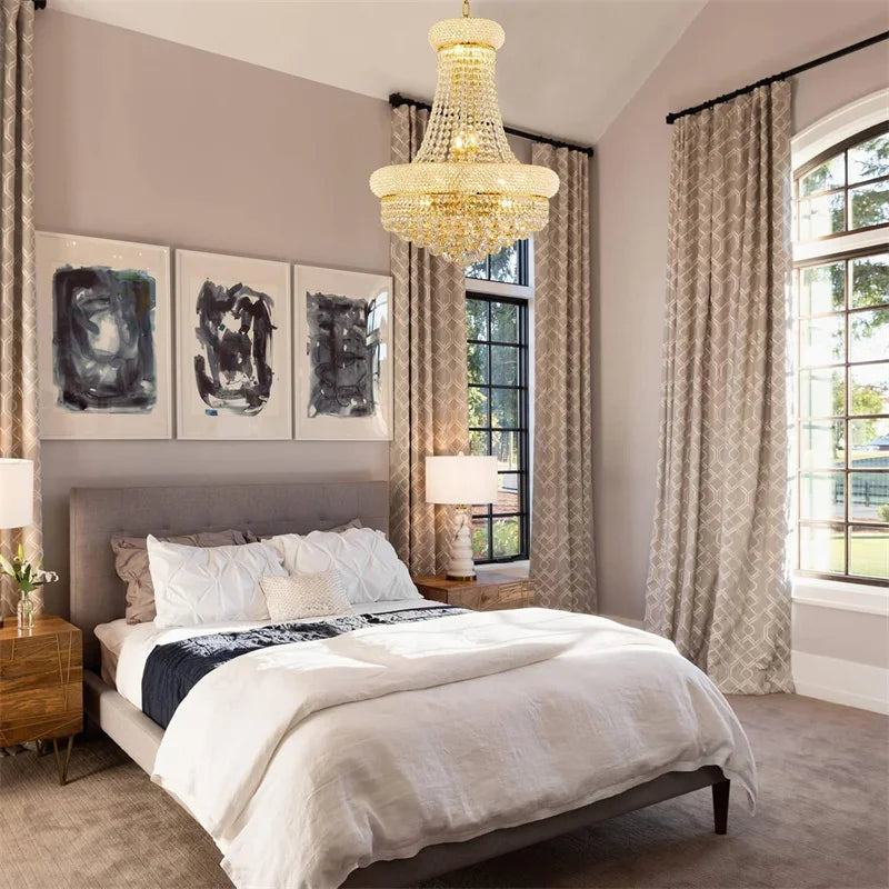 Luxurious bedroom with a chandelier, bed, and large windows.