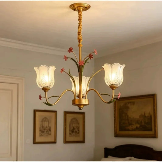 Gold floral ceramic chandelier with tulip-shaped glass shades, mounted on a ceiling.