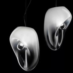 Two smoke gray glass organic shape pendant lights against a black background.