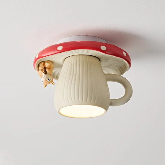 Close-up of a red and white mushroom-shaped ceiling light with a small squirrel hanging off the side, illuminating downwards.