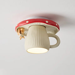 Close-up of a red and white mushroom-shaped ceiling light with a small squirrel hanging off the side, illuminating downwards.