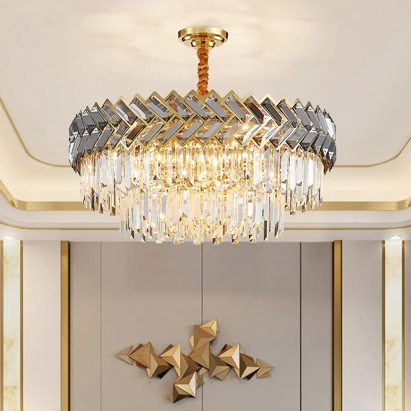 Close-up view of a gold-toned chandelier showcasing its tiered crystal design and polished finish, with warm light illuminating the crystals.