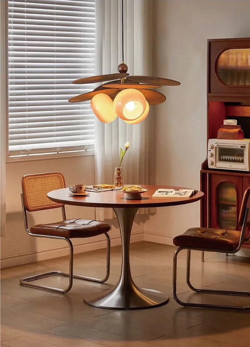 Dining room with a round table, chairs, and a ceiling light fixture.