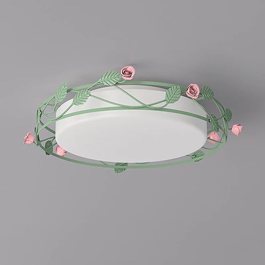 Close-up view of a green flush mount ceiling light featuring a floral vine design with pink roses and leaves.