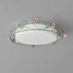 Close-up view of a green flush mount ceiling light featuring a floral vine design with pink roses and leaves.