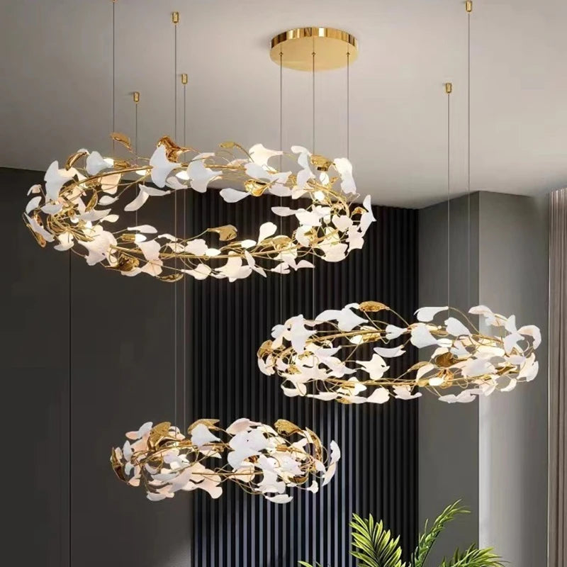 View of a gold leaf ring pendant light from below, showcasing its layered structure and illuminated details.