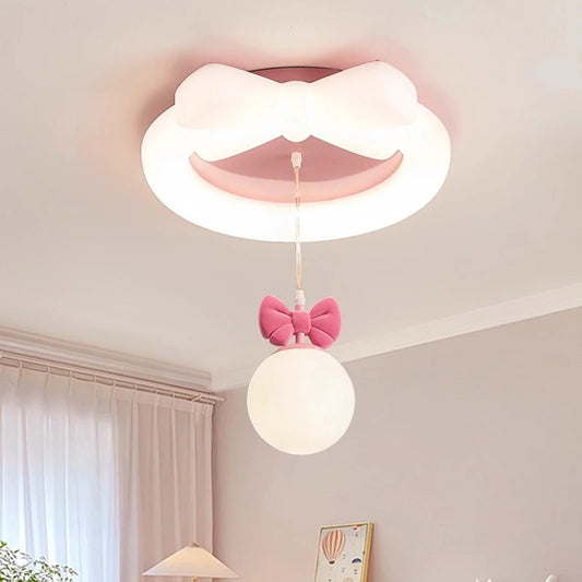 Close-up of the white ceiling light with pink bow, showing the integrated LED ring and the hanging orb light with pink bow detail.