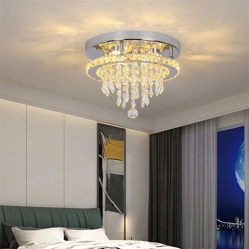 Chandelier hanging in a bedroom with a bed and wall art in the background