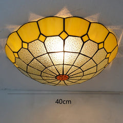 Close-up of a yellow stained glass ceiling light with a scalloped edge and a 40cm diameter indicated.
