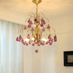 Gold chandelier with cascading purple droplet crystals and polished finish.