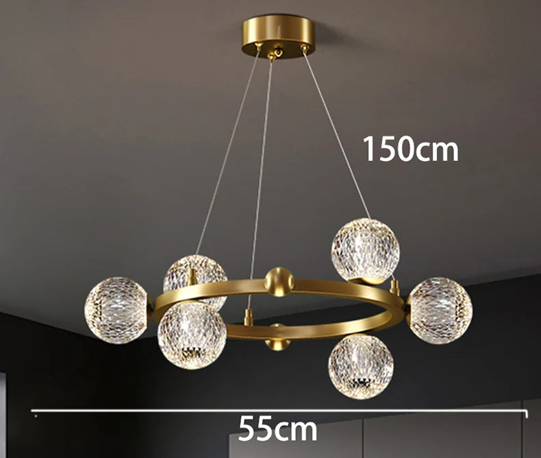 Gold chandelier with crystal balls on a dark ceiling, showing dimensions.
