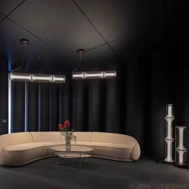 Modern living room with a beige sofa, glass coffee table, and decorative elements.