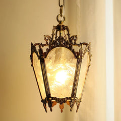 A close-up of the polished copper floral glass pendant light, illuminated from within, showcasing its detailed metalwork and textured glass.