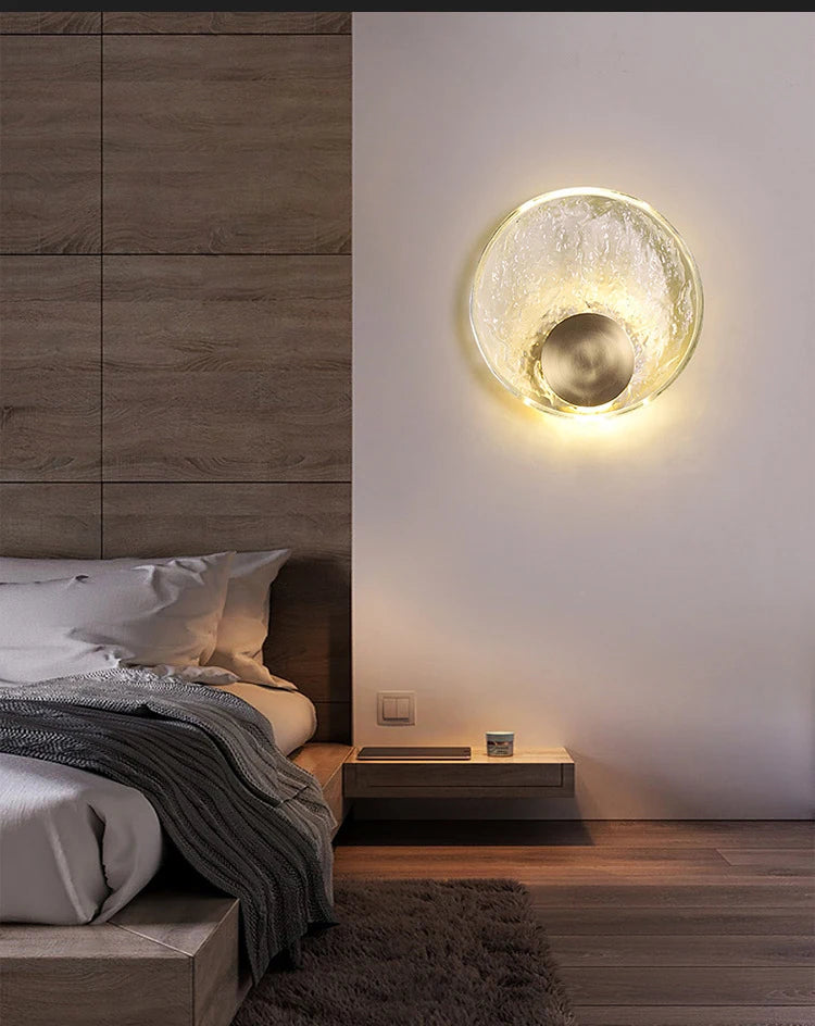 Modern bedroom with a wall-mounted light fixture casting a warm glow.