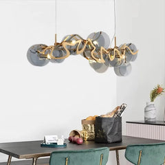 Gold wavy glass pendant light above a dining table