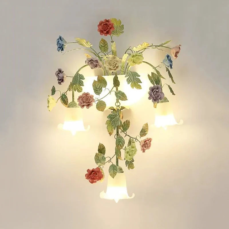 A different angle of the gold floral wall sconce, highlighting the upward facing clear glass shades.