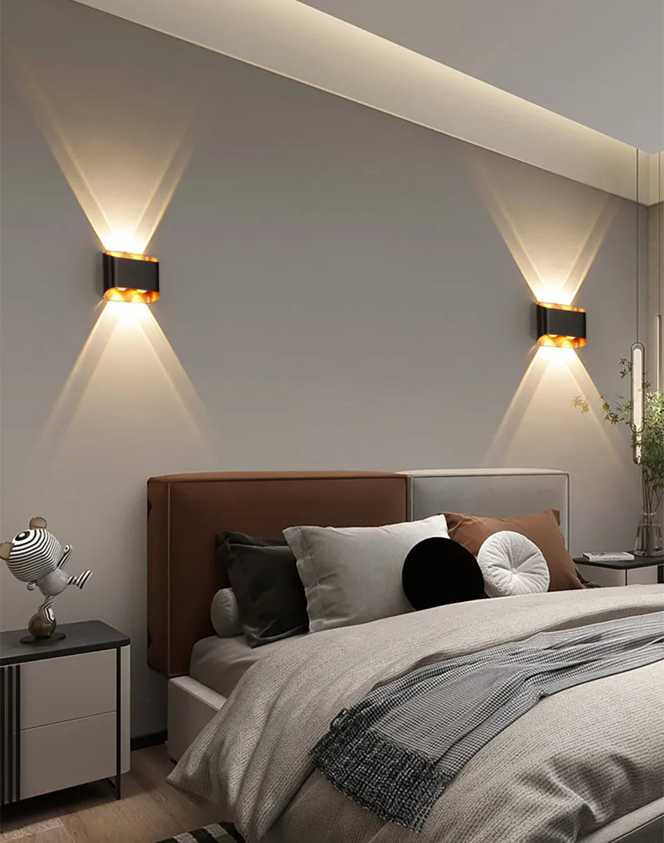 Modern bedroom with wall sconces, bed, and nightstands.