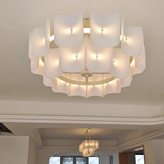 Gold tiered acrylic wave chandelier with multiple layered shades illuminated