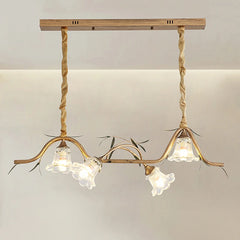 Close-up of a gold floral pendant light fixture showing the ornate metalwork and glass shades.
