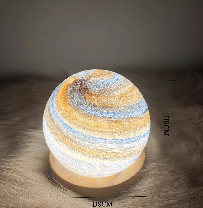 Decorative lamp with swirling design on a textured surface