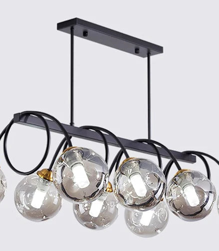 Modern chandelier with clear glass bulbs and black metal frame on a light gray background