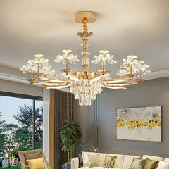 A side view of a gold chandelier featuring tiered crystal floral designs and a central cascade of teardrop crystals.