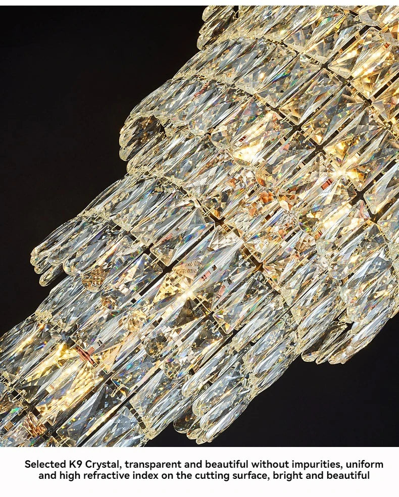 Close-up of a crystal chandelier with clear and gold crystals on a black background.